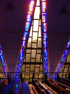 Sun setting behind the mountains,  viewed through a stained glass window